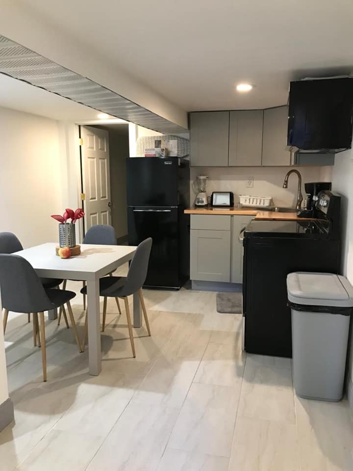 Furnished kitchen and dining area in a Brooklyn Medical Housing apartment.